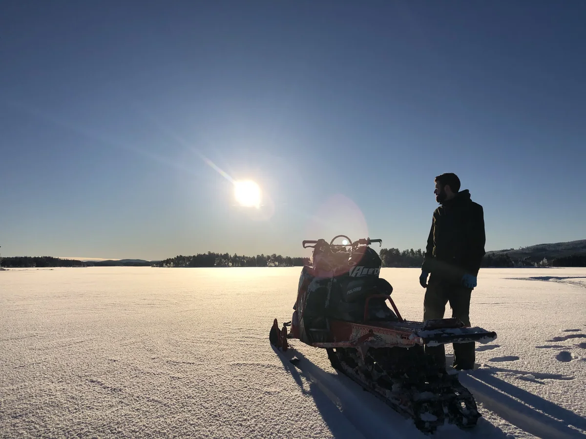 A winter day with a snowmobile on the frozen lake in Närsen